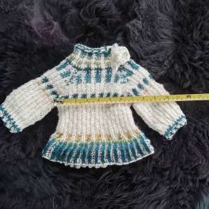 Babypulli mit Schösschen Größe 64